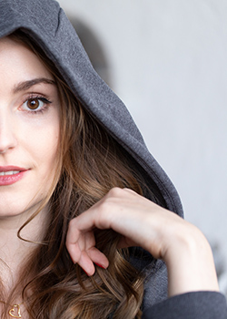 Portrait of a young woman with hood.